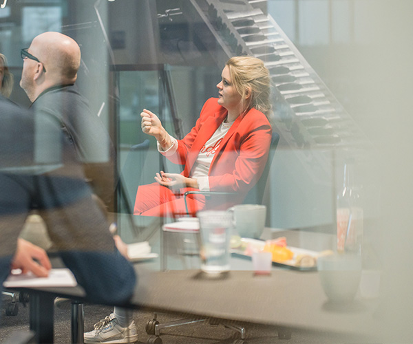 Onboarding_600x500-3 Kvinde i rødt jakkesæt taler om onboarding